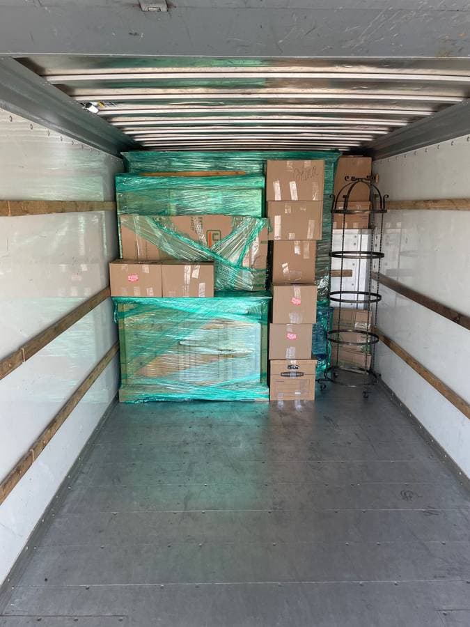 picture of inside of a box truck with cardboard boxes neatly lined up.  